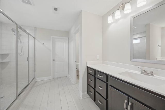 1200 Eagles Bluff Dr, Clarksville, TN 37040 - bathroom featuring a stall shower, vanity, baseboards, and toilet