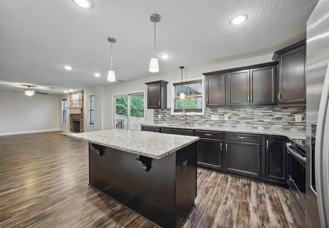 1200 Eagles Bluff Dr, Clarksville, TN 37040 - kitchen with open floor plan, decorative backsplash, stainless steel appliances, dark wood finished floors, and recessed lighting