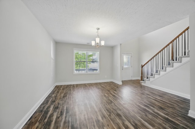 1200 Eagles Bluff Dr, Clarksville, TN 37040 - interior space with stairs, a chandelier, dark wood-style flooring, a textured ceiling, and baseboards