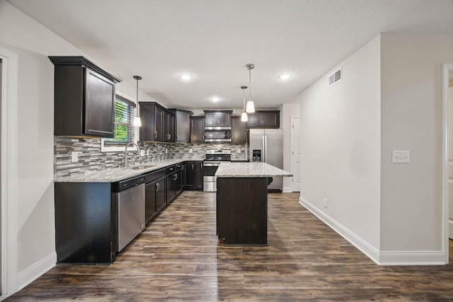 1200 Eagles Bluff Dr, Clarksville, TN 37040 - kitchen featuring appliances with stainless steel finishes, a sink, backsplash, light stone countertops, and dark wood finished floors
