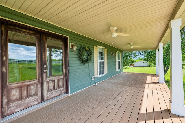 deck with a ceiling fan and covered porch