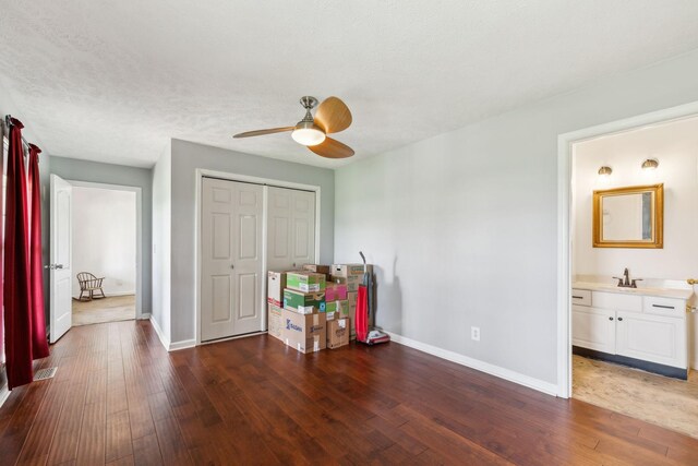 bedroom featuring hardwood / wood-style floors, baseboards, and a closet