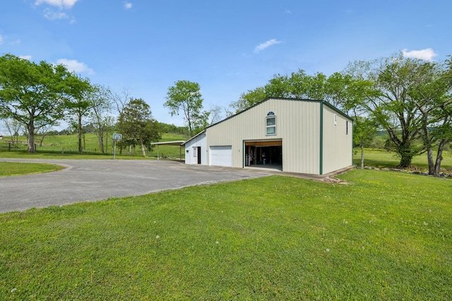 view of outbuilding with an outdoor structure and aphalt driveway