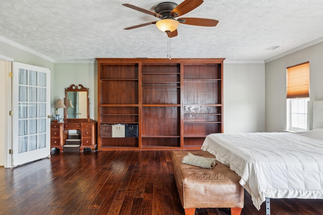 bedroom featuring wood-type flooring, a textured ceiling, crown molding, and visible vents