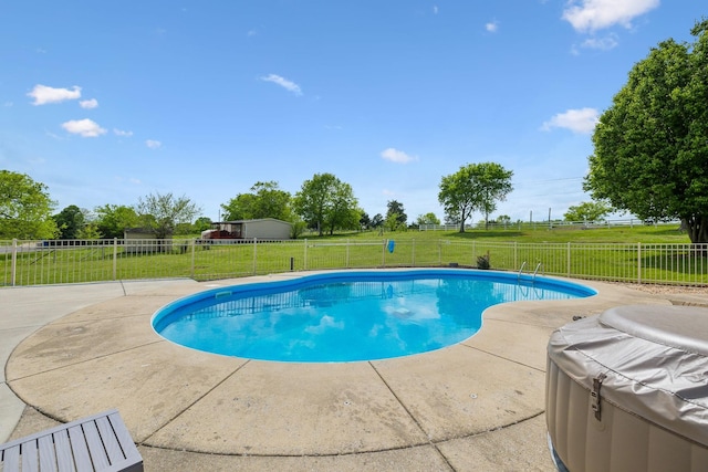 view of swimming pool with fence, a lawn, a fenced in pool, and a patio area