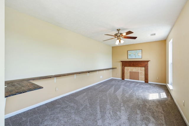 unfurnished living room with baseboards, a ceiling fan, visible vents, and carpet