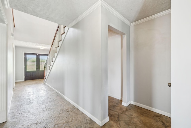 corridor featuring baseboards, ornamental molding, a textured ceiling, and stairway