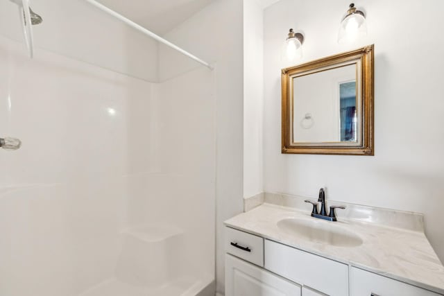 bathroom with vanity and a shower