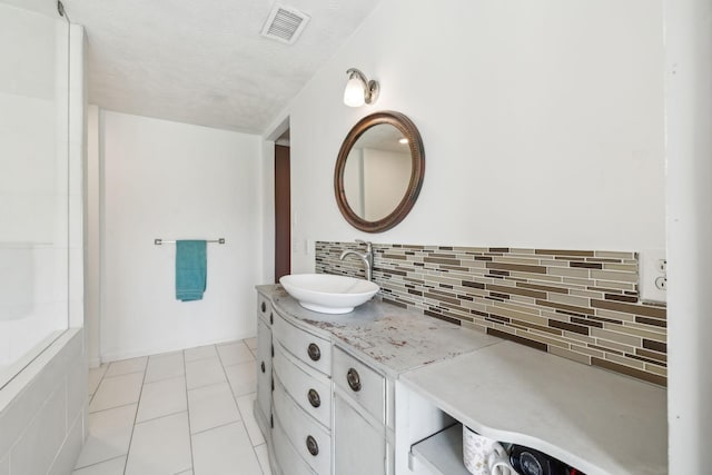 bathroom with tile patterned flooring, decorative backsplash, vanity, and visible vents