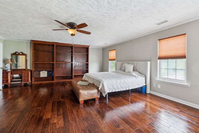 bedroom featuring baseboards, visible vents, ornamental molding, and wood-type flooring