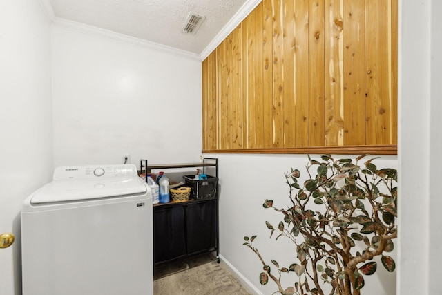 clothes washing area with visible vents, crown molding, laundry area, and washer / clothes dryer