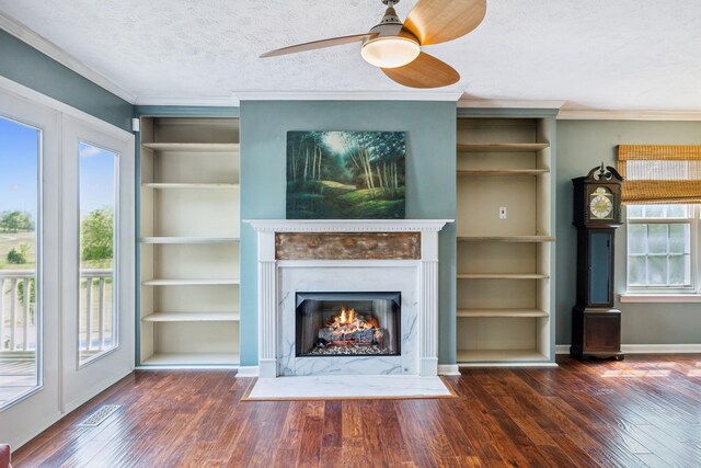 unfurnished living room featuring a wealth of natural light and wood finished floors