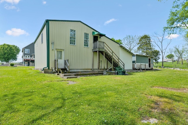 back of house with a yard, stairs, and a deck