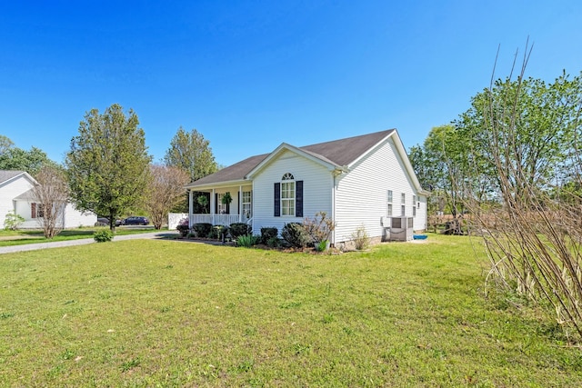 view of front of house featuring central AC, a front yard, and covered porch