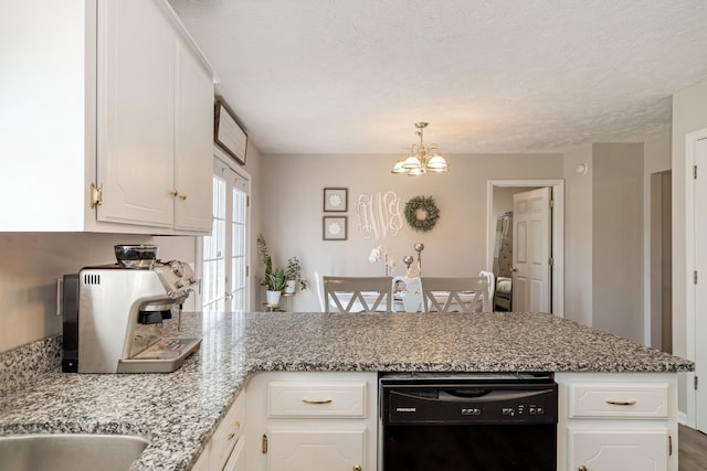 kitchen with white cabinets, a peninsula, a chandelier, and black dishwasher