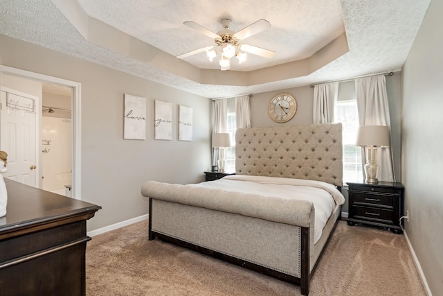 carpeted bedroom featuring a textured ceiling, baseboards, and multiple windows