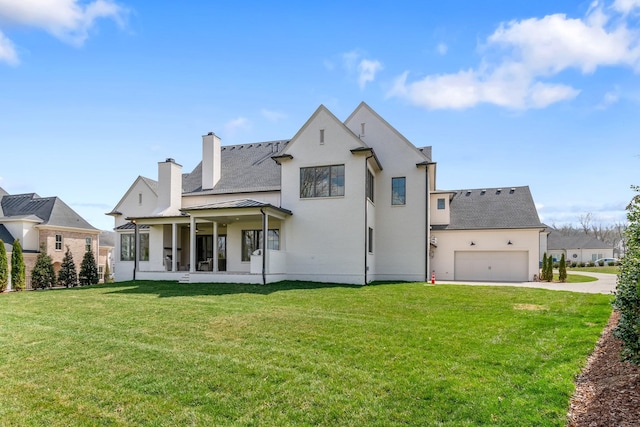9322 Joslin Ct, Brentwood, TN 37027 - rear view of house featuring a standing seam roof, a yard, a chimney, concrete driveway, and an attached garage