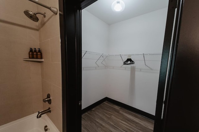 walk in closet featuring dark wood-style floors