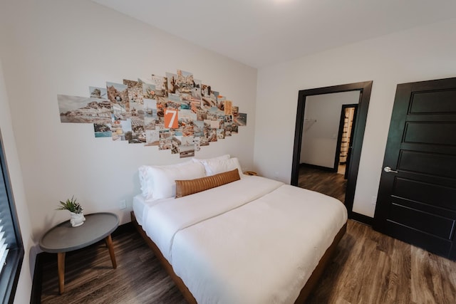 bedroom with dark wood-type flooring