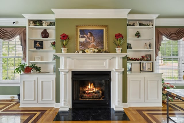 sitting room featuring a fireplace with flush hearth and a healthy amount of sunlight