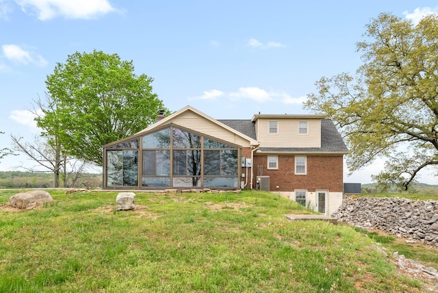 13391 Fruit Hill Red Bridge Rd, Crofton, KY 42217 - back of house featuring brick siding, central AC unit, a sunroom, and a yard