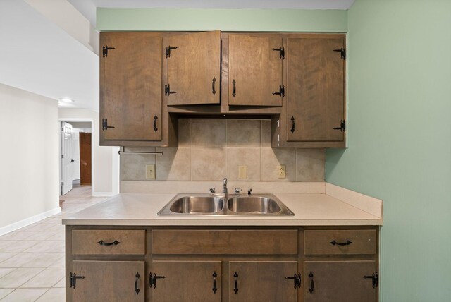 13391 Fruit Hill Red Bridge Rd, Crofton, KY 42217 - kitchen featuring light countertops, light tile patterned floors, a sink, baseboards, and tasteful backsplash