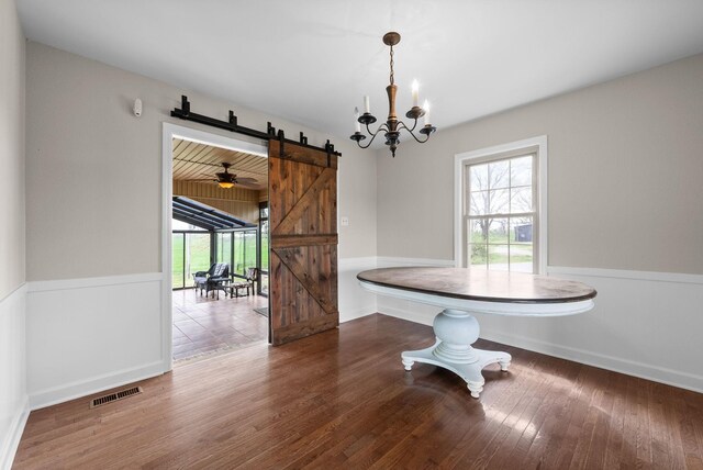 13391 Fruit Hill Red Bridge Rd, Crofton, KY 42217 - dining space featuring wood finished floors, a healthy amount of sunlight, a notable chandelier, and a barn door