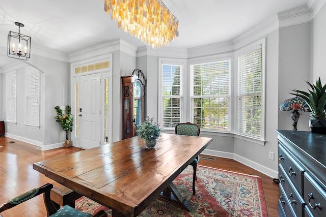 interior space featuring visible vents, dark wood-type flooring, arched walkways, baseboards, and a chandelier