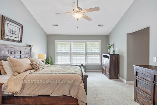 bedroom featuring lofted ceiling, visible vents, and light carpet