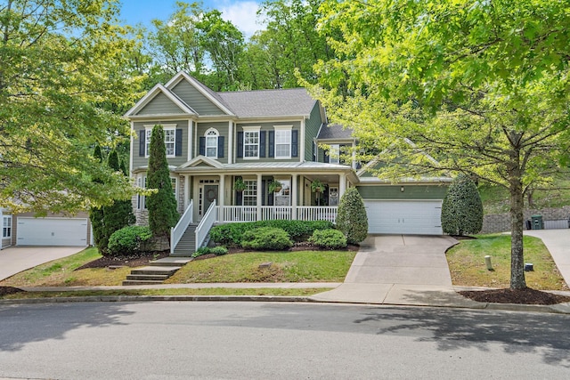view of front of property featuring a garage, covered porch, a shingled roof, and concrete driveway