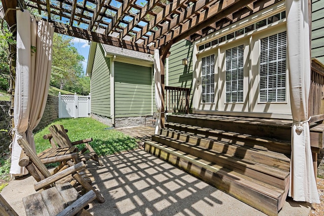 view of patio / terrace with fence, a pergola, and a gate