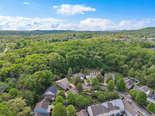 birds eye view of property with a view of trees and a residential view