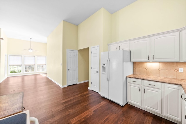kitchen featuring white fridge with ice dispenser, backsplash, high vaulted ceiling, and dark wood finished floors