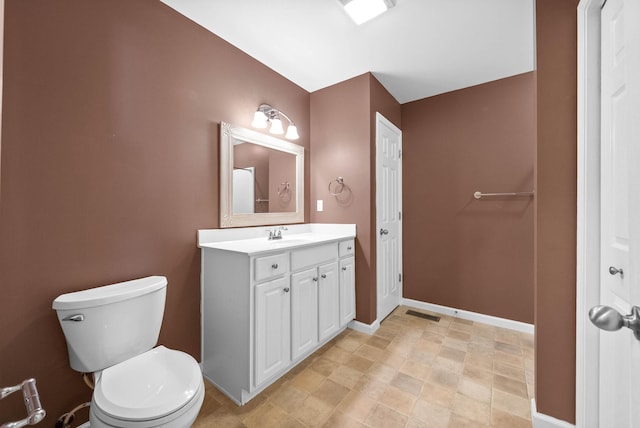 bathroom with baseboards, visible vents, toilet, and vanity