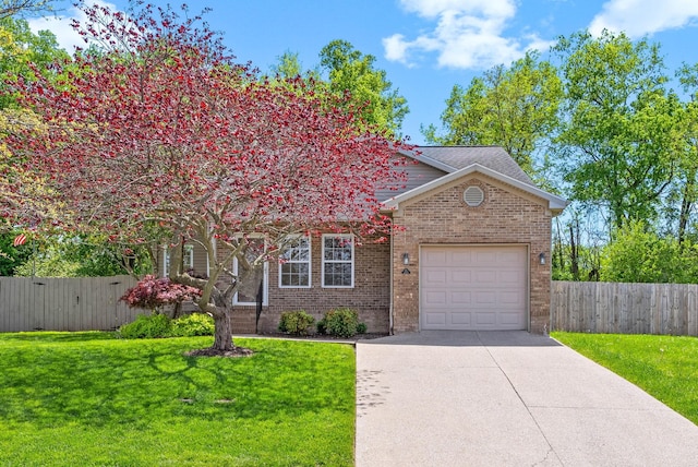 obstructed view of property featuring brick siding, an attached garage, fence, and driveway