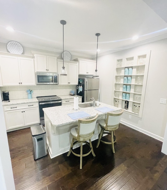 199 Evans Dr, Tullahoma, TN 37388 - kitchen featuring an island with sink, appliances with stainless steel finishes, a sink, and white cabinetry
