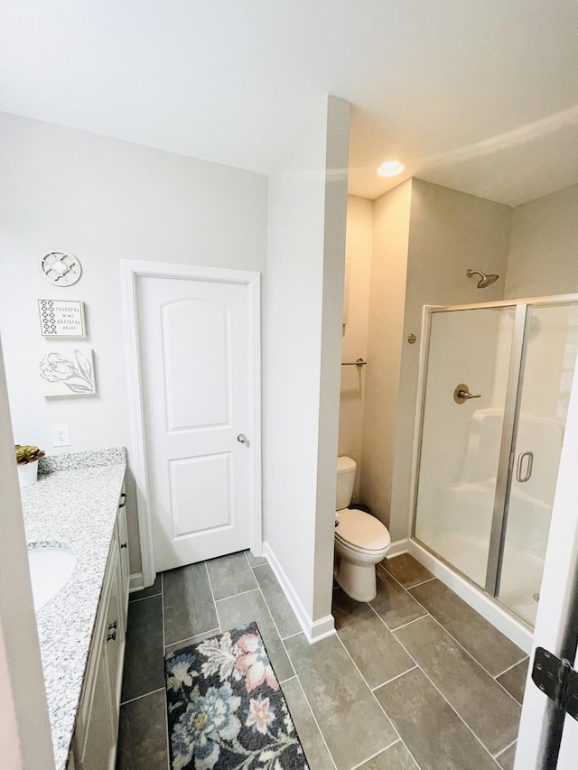 199 Evans Dr, Tullahoma, TN 37388 - full bathroom featuring a shower stall, toilet, vanity, baseboards, and tile patterned flooring