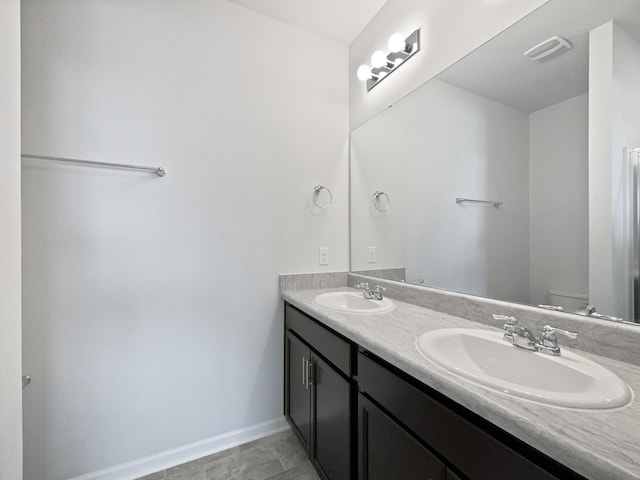 7007 Berkswell Dr, Lebanon, TN 37087 - bathroom featuring baseboards, a sink, double vanity, and toilet