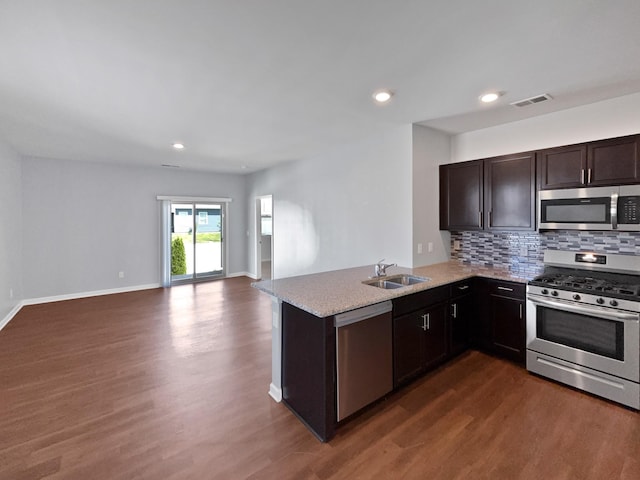 7007 Berkswell Dr, Lebanon, TN 37087 - kitchen with visible vents, a sink, dark wood-type flooring, tasteful backsplash, and appliances with stainless steel finishes