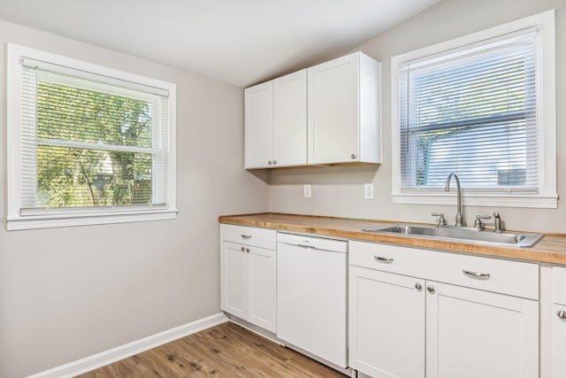111 3rd Ave, Mount Pleasant, TN 38474 - kitchen with light wood finished floors, dishwasher, a sink, baseboards, and white cabinetry