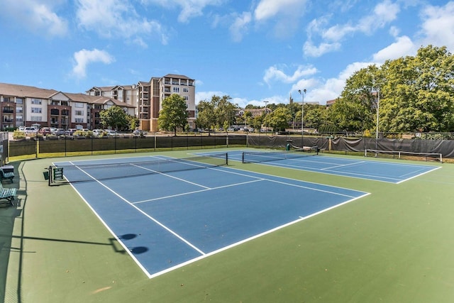 view of tennis court featuring fence and community basketball court