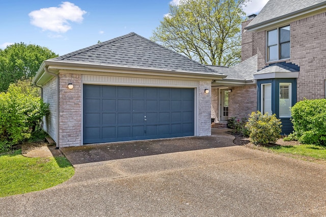 view of front of home with brick siding, a shingled roof, an attached garage, and aphalt driveway