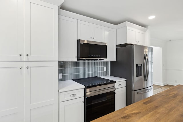 kitchen with recessed lighting, decorative backsplash, stainless steel appliances, white cabinets, and light wood finished floors