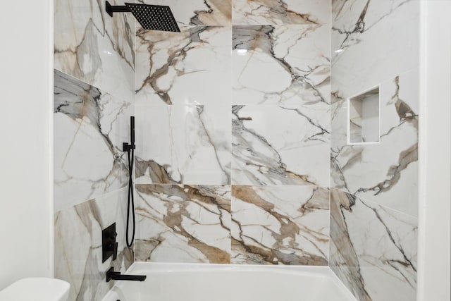full bathroom featuring toilet and a combined bath / shower with marble appearance