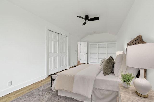bedroom featuring baseboards, wood finished floors, ceiling fan, and vaulted ceiling