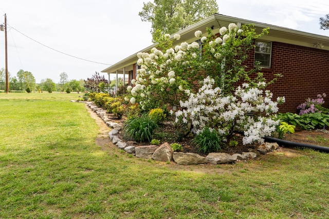 60 Sam Johnson Ln, Scotts Hill, TN 38374 - view of side of property featuring a yard
