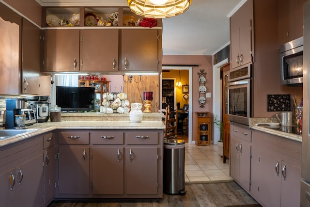 60 Sam Johnson Ln, Scotts Hill, TN 38374 - kitchen with light countertops, appliances with stainless steel finishes, and gray cabinets