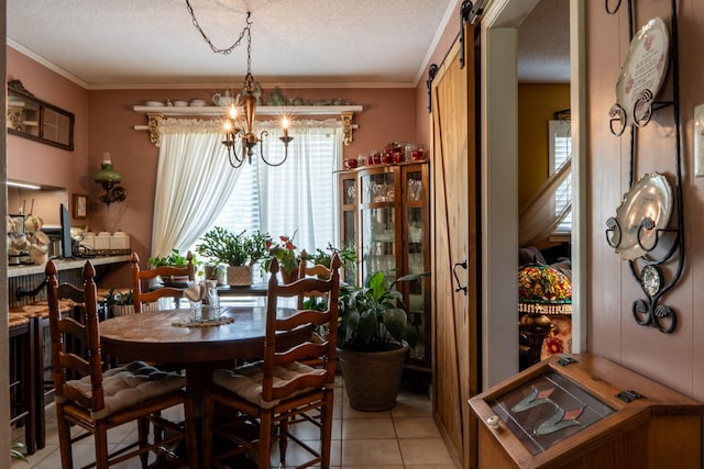 60 Sam Johnson Ln, Scotts Hill, TN 38374 - dining space featuring a barn door, an inviting chandelier, ornamental molding, light tile patterned flooring, and a textured ceiling