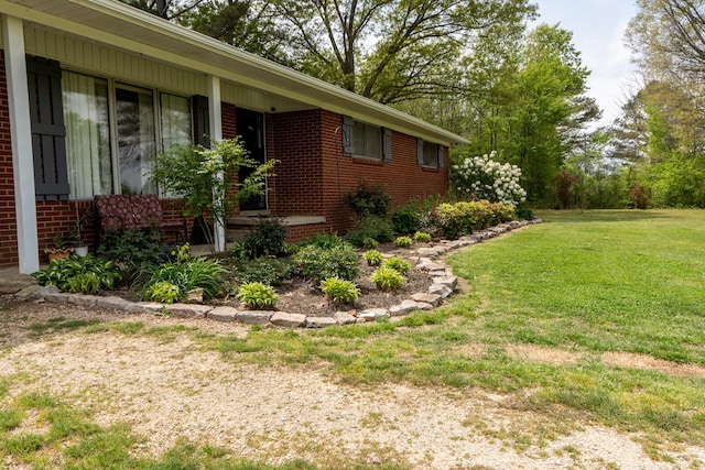 60 Sam Johnson Ln, Scotts Hill, TN 38374 - view of side of property featuring a lawn and brick siding