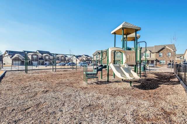community jungle gym featuring fence and a residential view